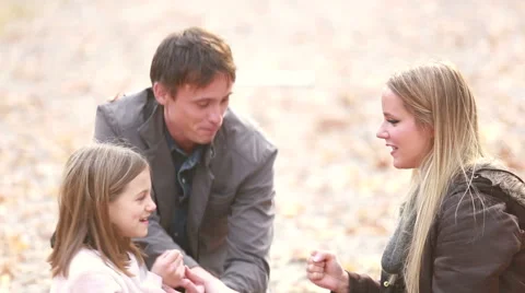 Mom and daughter playing a game of rock, paper, scissors in the park Stock Footage 59554286