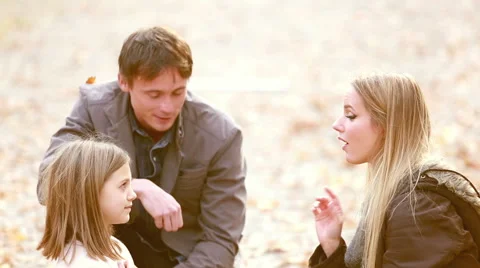 Mom and daughter playing a game of rock, paper, scissors in the park Stock Footage 59554297