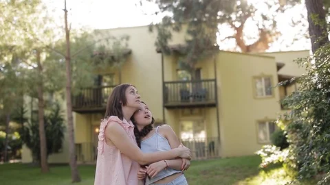 Mom and daughter teenager in the garden admire nature. Stock Footage