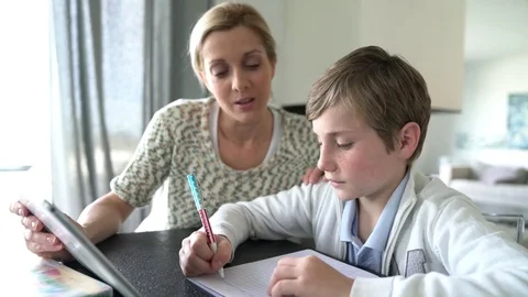 Mom and son doing homework with digital tablet Stock Footage