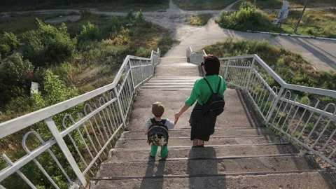 Mom and son go down the bridge over the railway Stock-Footage 219636112