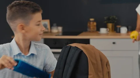 Mom and son prepare a backpack for the first school day Stock Footage 92839780