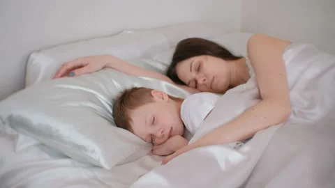 Mom and son sleeping together. Mom huggi... | Stock Video | Pond5