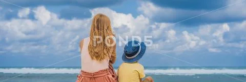 Mom and son travelers on amazing Melasti Beach with turquoise water, Bali Island Stock Photos