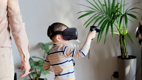 Mom and son use virtual reality glasses while playing virtual games at home Stock Footage 220072251