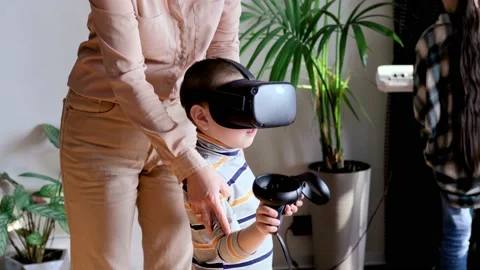 Mom and son use virtual reality glasses while playing virtual games at home Stock Footage 220072342