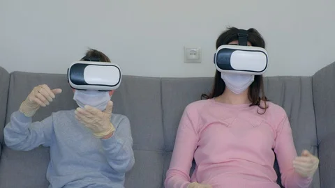 Mom and son using virtual reality glasses in coronavirus pandemic quarantine. Stock-Footage 128983225