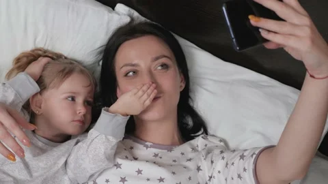 Mom, baby take a picture on smartphone, Stock Video Pond5