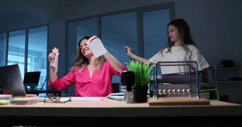 Mom Balancing Work Responsibilities and Family Life in a Modern Office Stock Footage 294546840