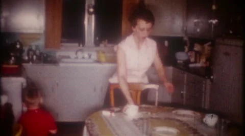 Mom cleans kitchen prepares for dinner 1950s vintage film home movie 3648 Stock Footage