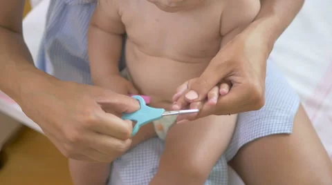 Mom cuts the nails on the hands of a child. Stock Footage