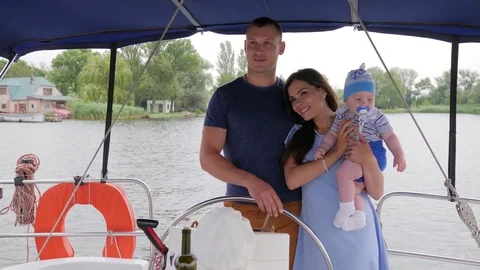 Mom, daddy and young child during summer holidays on river, spouse and wife with Stock Footage