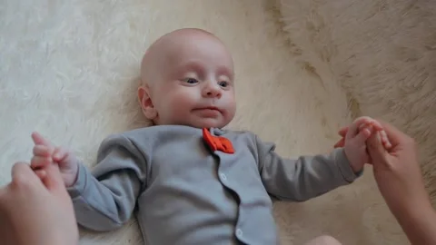 Mom Does Hand Exercises With Her Little Baby. Child Development And Child Care Stock Footage 131611506