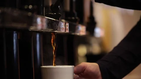A mom gets coffee at a buffet while on vacation at a hotel. Stock Footage 147970867