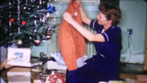 Mom gets a nice leather jacket on Christmas morning 1950s family home movie 7469 Stock Footage 258195242