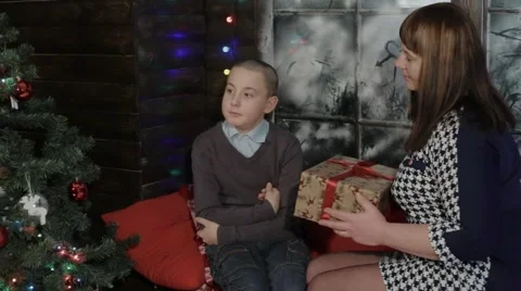 Mom gives his son a gift for the new year Stock Footage 59188096