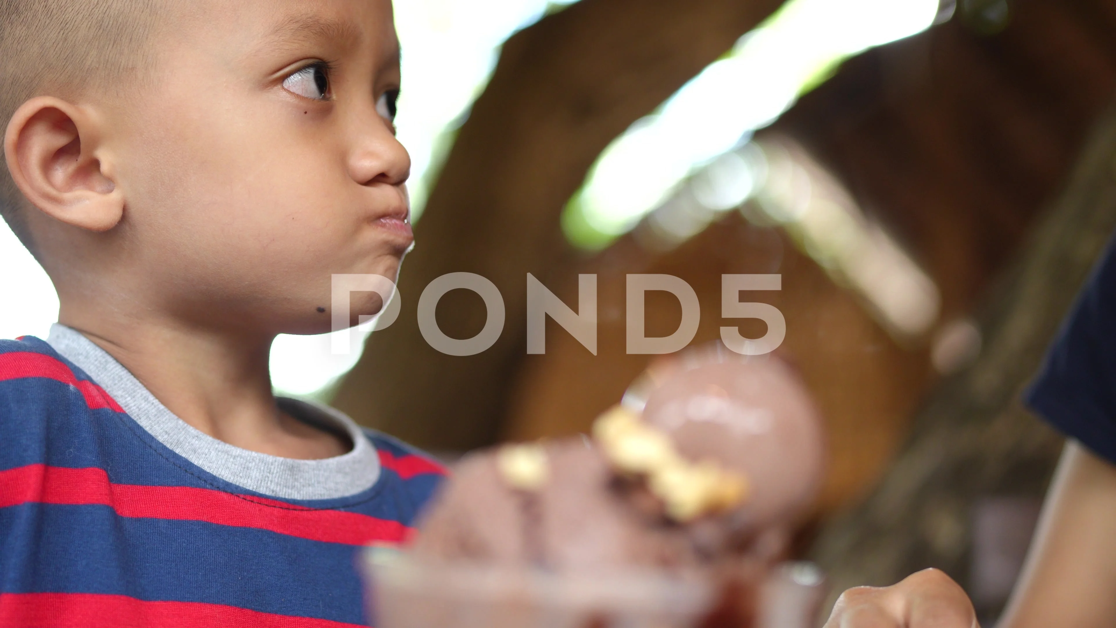 Mom gives ice cream to son to eat.