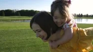 Mom Giving Piggyback Ride To Special Daughter Stock Footage