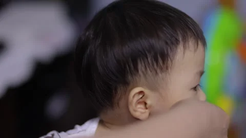 Mom hands clean the first teeth of her little baby son Video stock 254104075