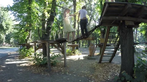 Mom helps the boy down from climbing simulator. Video stock 59143823