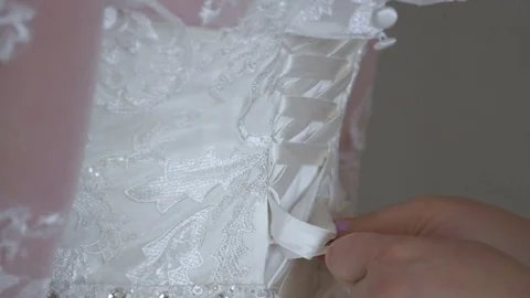 Mom helps the bride to wear a wedding dress. Stock Footage