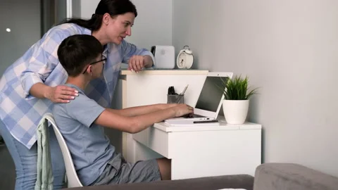 Mom helps her son do his homework. Stock Footage 239376199