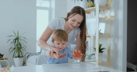 Mom helps her son to make a handprint on... | Stock Video | Pond5