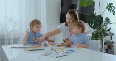 Mom helps her sons to develop creative skills and is engaged with them to create Stock Footage 105117979