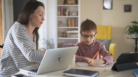 Mom helps son do homework on distant learning during quarantine. Spbd modern Stock Footage 128312989