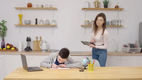 Mom helps to son with homework Stock Footage 273593728