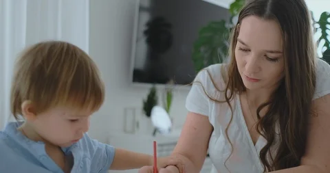 Mom helps two sons of 2 and 4 years old | Stock Video | Pond5