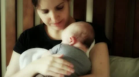 Mom holding baby after breastfeeding Stock Footage