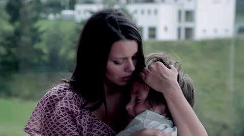 Mom hugging and talking to little child crying Stock Footage