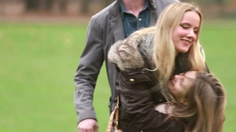 Mom hugging daughter in park Stock Footage 59554475