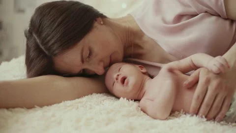 mom lying next to her newborn Stock Video Pond5