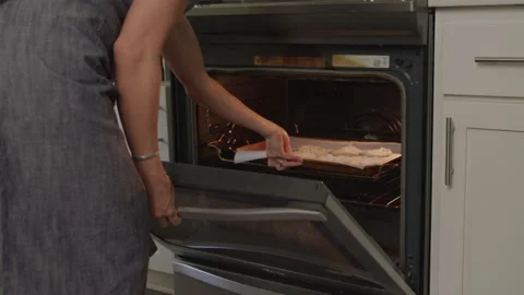 Mom Opens Oven and Puts Cookies in to Bake Stock Footage 208765577