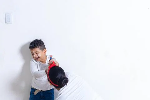 Mom playing her son while painting Stock Photos