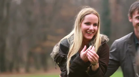 Mom playing with husband and daughter in park Stock Footage 59554497