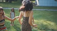 Mom Plays With Her Children On The Lawn In A Summer Park Stock Footage