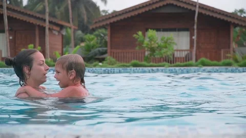 Mom plays in the pool with her son. Sports games are good for health. 스톡 동영상 178544827