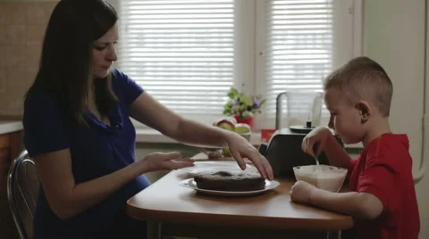 Mom putting a part of cake a side Stock Footage 62819498