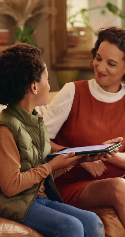 Mom, son and tablet on sofa for elearning, bonding and educational app in home Stock Footage 343305757