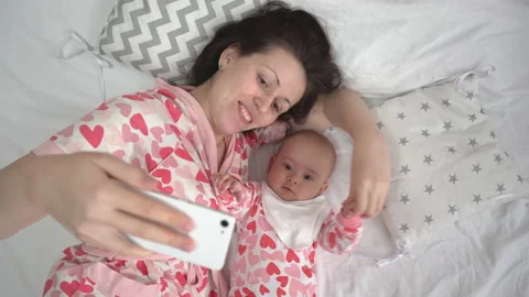 Mom takes a selfie with her newborn daug... | Stock Video | Pond5
