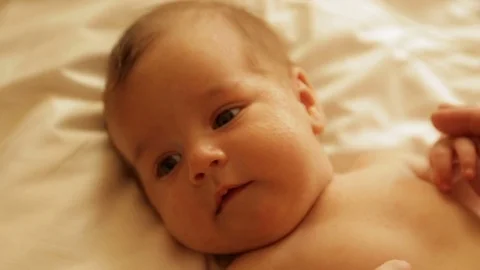 Mom tenderly embraced the baby's small hands Stock Footage