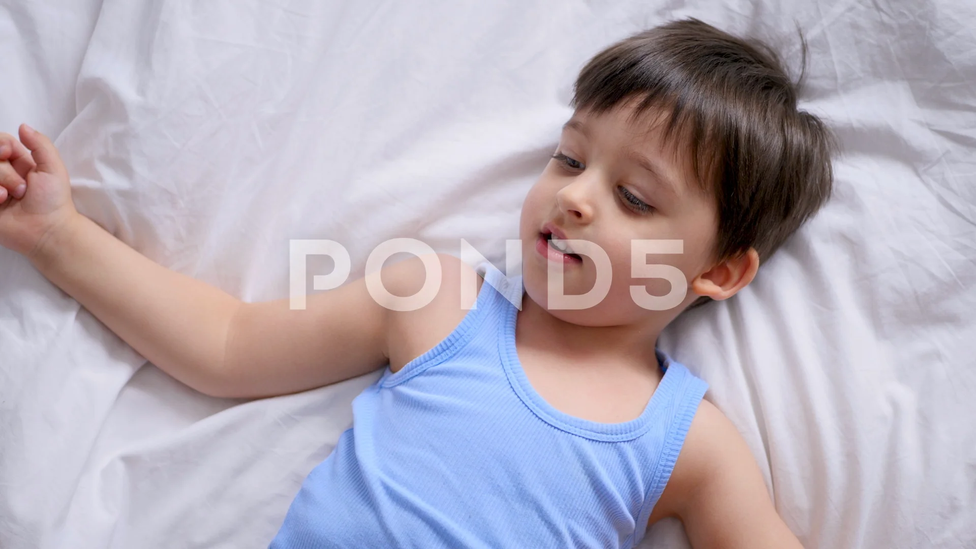 mom tickles her little son lying on the ... | Stock Video | Pond5