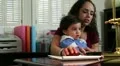 Mom trying to get some office work done HD Footage