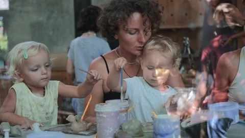 Mom with two charming daughters at a master class in clay modeling. Children Video stock 182755250