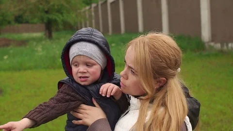 Mom wipes tears from the face of her little son. Stock Footage