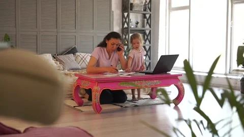 Mom working remotely. Multitasking for Work-at-Home woman. Stressed mother Stock Footage 136539428