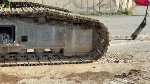 The moment a construction machine is loaded onto or unloaded from a transport Stock Footage 332626497